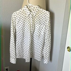 White and navy polka dot button-up blouse.